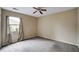 Simple bedroom with neutral walls, a ceiling fan, and carpet flooring; perfect for customization at 104 Woodhaven Way, Alpharetta, GA 30009