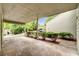 Covered carport with concrete flooring, lush greenery, and a glimpse of a neighboring property at 104 Woodhaven Way, Alpharetta, GA 30009