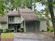 Charming home with a covered carport, lush landscaping and mature trees in a desirable neighborhood at 104 Woodhaven Way, Alpharetta, GA 30009