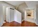 Foyer featuring wood floors, coat rack and staircase with easy access to the fireplace and living room at 104 Woodhaven Way, Alpharetta, GA 30009