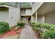 Charming front entrance with a stone walkway, lush landscaping, and a welcoming doorway at 104 Woodhaven Way, Alpharetta, GA 30009