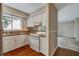 Bright kitchen features white cabinets and an electric range at 104 Woodhaven Way, Alpharetta, GA 30009