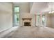Bright and airy living room featuring a stone fireplace, vaulted ceiling and sliding glass doors at 104 Woodhaven Way, Alpharetta, GA 30009