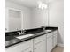 Bathroom boasts double vanity with dark granite countertop at 505 Paces Dr, Lithia Springs, GA 30122
