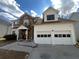 Home exterior featuring a two-car garage and stone facade at 6383 Phillips Ct, Lithonia, GA 30058