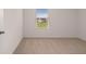 Spacious bedroom with neutral carpeting and large window at 175 Amberjack Trail, Covington, GA 30016
