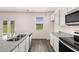 Modern kitchen with granite countertops and stainless steel appliances at 175 Amberjack Trail, Covington, GA 30016