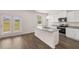 Modern kitchen with island, granite countertops, and stainless steel appliances at 175 Amberjack Trail, Covington, GA 30016