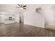 Open living room with kitchen and stairs, featuring hardwood floors at 175 Amberjack Trail, Covington, GA 30016
