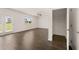 Open living room with dark laminate floors and access to patio at 175 Amberjack Trail, Covington, GA 30016