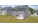Aerial view of backyard with gray two-story house, concrete patio, and adjacent landscaped terrace at 205 Amberjack Trail, Covington, GA 30016