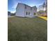 Spacious backyard featuring a well-maintained lawn and a two-story house at 2180 Highridge Point Dr, Lithia Springs, GA 30122