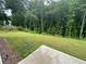 Lawn with concrete patio area, ideal for outdoor entertaining and relaxation at 2180 Highridge Point Dr, Lithia Springs, GA 30122