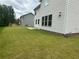 View of the backyard with a green lawn and vinyl siding on the side of the home at 2180 Highridge Point Dr, Lithia Springs, GA 30122