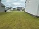 Backyard with green grass and vinyl siding on the side of the home at 2180 Highridge Point Dr, Lithia Springs, GA 30122