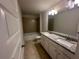 Bathroom featuring double sinks, granite countertops and a tub shower at 2180 Highridge Point Dr, Lithia Springs, GA 30122