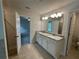 Bathroom featuring granite countertops, a dual vanity, tile floors and modern lighting at 2180 Highridge Point Dr, Lithia Springs, GA 30122