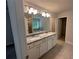 Well-lit bathroom with double sink vanity, granite countertop, and tiled floor at 2180 Highridge Point Dr, Lithia Springs, GA 30122