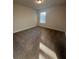 Sun-drenched bedroom featuring neutral carpet and a large window at 2180 Highridge Point Dr, Lithia Springs, GA 30122