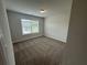 Cozy bedroom with neutral carpet, light-filled window, and fresh paint at 2180 Highridge Point Dr, Lithia Springs, GA 30122