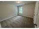 Bedroom featuring neutral carpet, one window and a white door at 2180 Highridge Point Dr, Lithia Springs, GA 30122