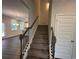 View of the staircase, door to a closet, and open concept living area at 2180 Highridge Point Dr, Lithia Springs, GA 30122