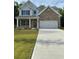 Charming two-story home features a brick facade, attached two-car garage, and concrete driveway at 2180 Highridge Point Dr, Lithia Springs, GA 30122