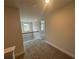 Hallway with neutral carpet and black metal railing leading to an adjacent bedroom at 2180 Highridge Point Dr, Lithia Springs, GA 30122