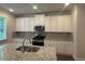 Gourmet kitchen featuring stainless steel appliances and gray backsplash at 2180 Highridge Point Dr, Lithia Springs, GA 30122