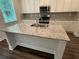 Granite island with stainless steel faucet in new construction kitchen at 2180 Highridge Point Dr, Lithia Springs, GA 30122