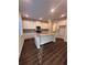 Bright kitchen with an island, modern appliances, granite countertops, and white cabinetry at 2180 Highridge Point Dr, Lithia Springs, GA 30122