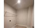 Laundry room with tile floor and wire rack shelving at 2180 Highridge Point Dr, Lithia Springs, GA 30122