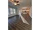 Open-concept living room with hardwood floors connects to modern kitchen with large windows at 2180 Highridge Point Dr, Lithia Springs, GA 30122