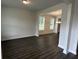 Spacious living area featuring elegant hardwood flooring and large windows, perfect for entertaining and relaxation at 2180 Highridge Point Dr, Lithia Springs, GA 30122