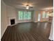Comfortable living area with a cozy fireplace and large windows, providing ample light and warmth at 2180 Highridge Point Dr, Lithia Springs, GA 30122