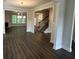 Open-concept living room seamlessly connected to dining area, showcasing hardwood floors and abundant natural light at 2180 Highridge Point Dr, Lithia Springs, GA 30122