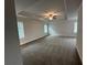 Spacious main bedroom with neutral walls and carpet, a ceiling fan, and large windows at 2180 Highridge Point Dr, Lithia Springs, GA 30122