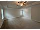 Spacious main bedroom with neutral walls and carpet, a ceiling fan, and large windows at 2180 Highridge Point Dr, Lithia Springs, GA 30122