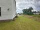 Side yard with lush green lawn and vinyl siding at 2180 Highridge Point Dr, Lithia Springs, GA 30122