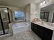 Bathroom with soaking tub, shower, and double vanity at 2368 Misty Ivy Ct, Buford, GA 30519