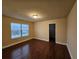 Bright bedroom featuring hardwood floors and a closet at 2368 Misty Ivy Ct, Buford, GA 30519