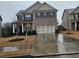 Brick two-story home with a three-car garage at 2368 Misty Ivy Ct, Buford, GA 30519