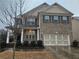 Brick two-story home with a three-car garage at 2368 Misty Ivy Ct, Buford, GA 30519