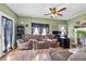 Living room featuring a fireplace, ceiling fan, and ample seating at 2930 Dallas Nw St, Kennesaw, GA 30144