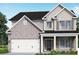 Two story house with neutral siding and a three car garage at 515 Paces Dr, Lithia Springs, GA 30122