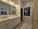Modern bathroom with double sinks, white cabinets, and marble floors for a sleek look at 1089 Avon Sw Ave, Atlanta, GA 30310
