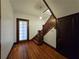 Inviting hallway with hardwood floors, natural light, and classic wooden staircase at 1089 Avon Sw Ave, Atlanta, GA 30310
