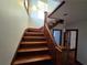 Elegant wood staircase featuring natural lighting and well-maintained wood detailing at 1089 Avon Sw Ave, Atlanta, GA 30310