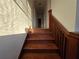 Hardwood staircase leading to the upper level, bathed in sunlight with wood railings at 1089 Avon Sw Ave, Atlanta, GA 30310