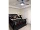 Bedroom with black sleigh bed, ceiling fan, and window blinds at 2708 Eagles Crest Ln, Decatur, GA 30034